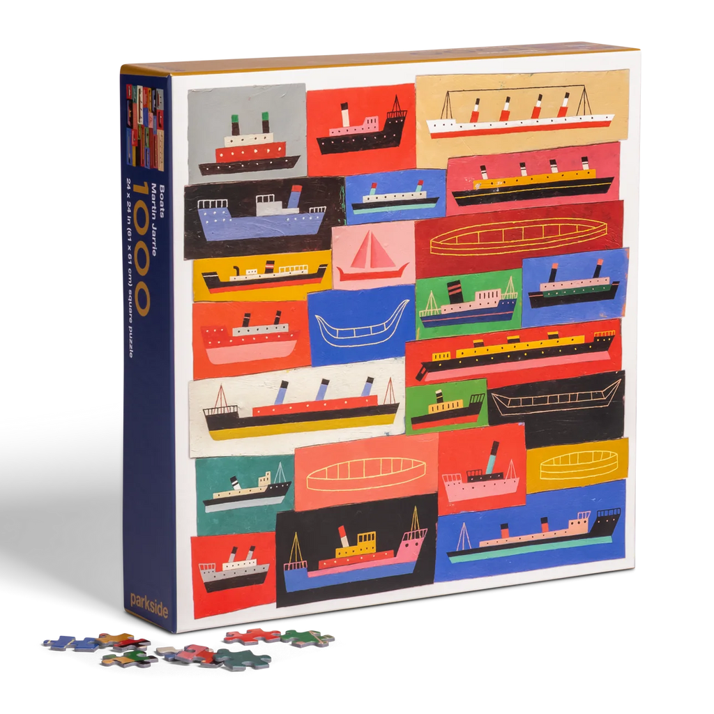 Puzzle box with colorful illustrations of boats and scattered puzzle pieces on a white background